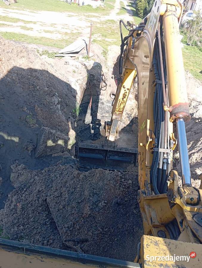 Usługi koparkoładowarką Cat 428D Pustków