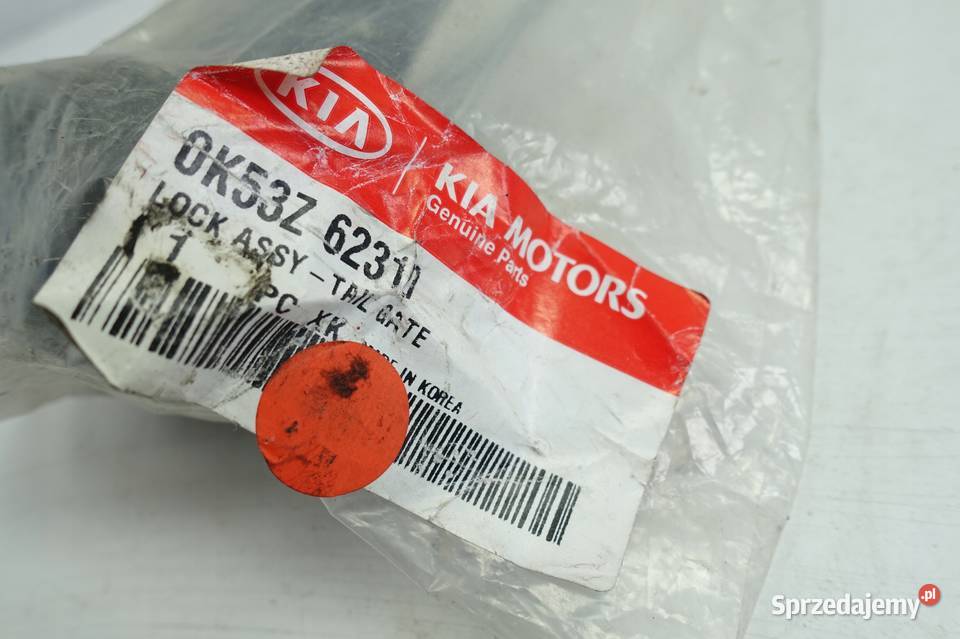 Kia Carnival I ZAMEK PRZEDNICH DRZWI prawy przód Rudka