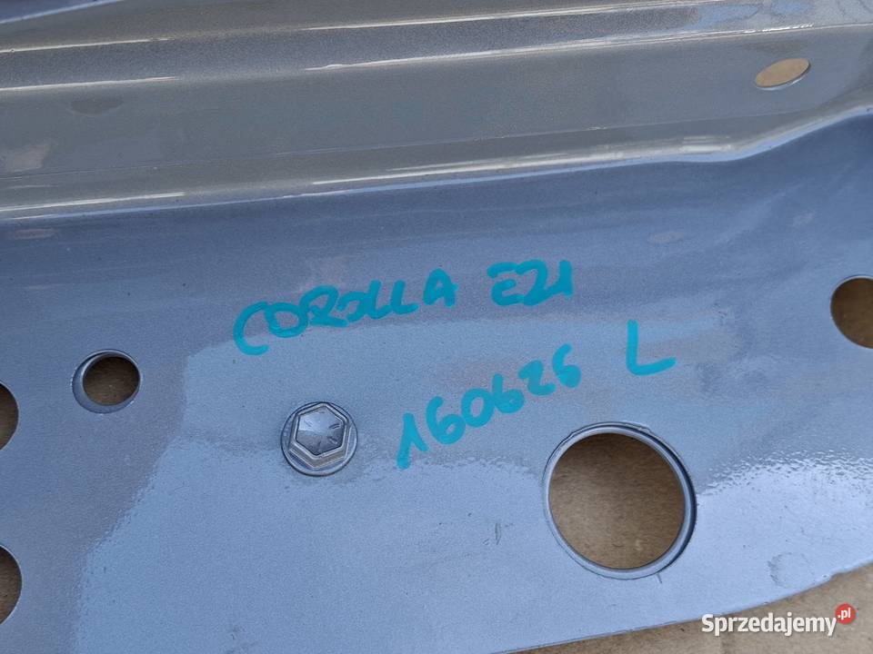 TOYOTA COROLLA E21 WSPORNIK PASA PRZEDNIEGO LEWY Pasy przednie i tylne Bieleń