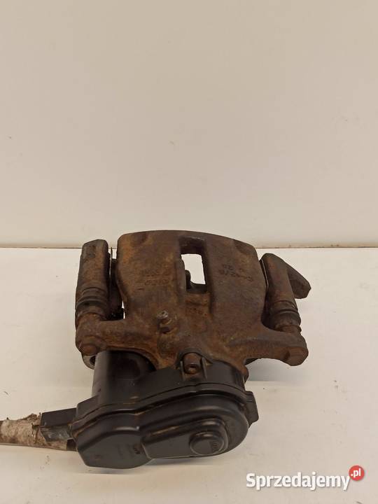 AUDI AA4 B8 ZACISK HAMULCOWY LEWY TYŁ 8K0615403E