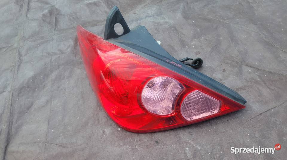 NISSAN TIIDA 5D LAMPA TYŁ LEWA 26555EM01A HELLA osobowe Ruda Śląska