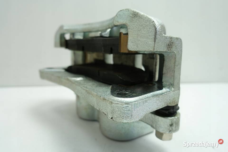 Kia Carnival I 29 CRDI PRZEDNI ZACISK HAMULCOWY Rudka