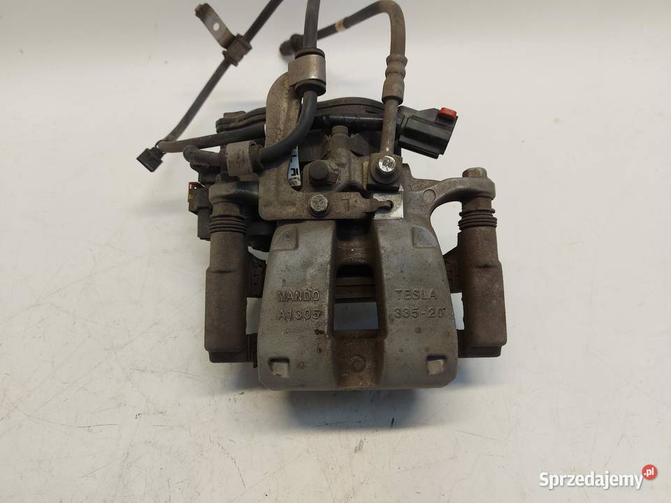 TESLA MODEL Y 2024r ZACISK HAMULCOWY LEWY TYŁ