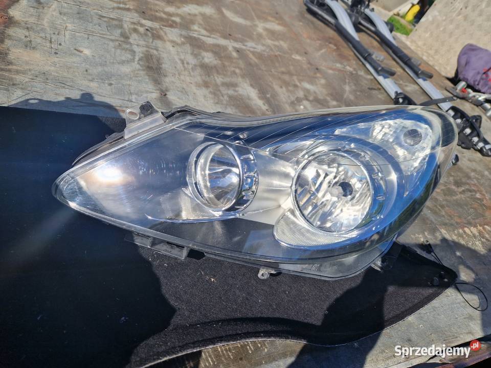 Opel Corsa D reflektor ORG EU Mielec