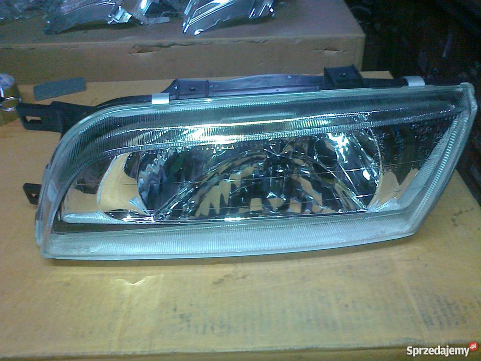 NISSAN ALMERA 9901 REFLEKTOR H4 LE REG ELE NOWY Oświetlenie Części sprzedam