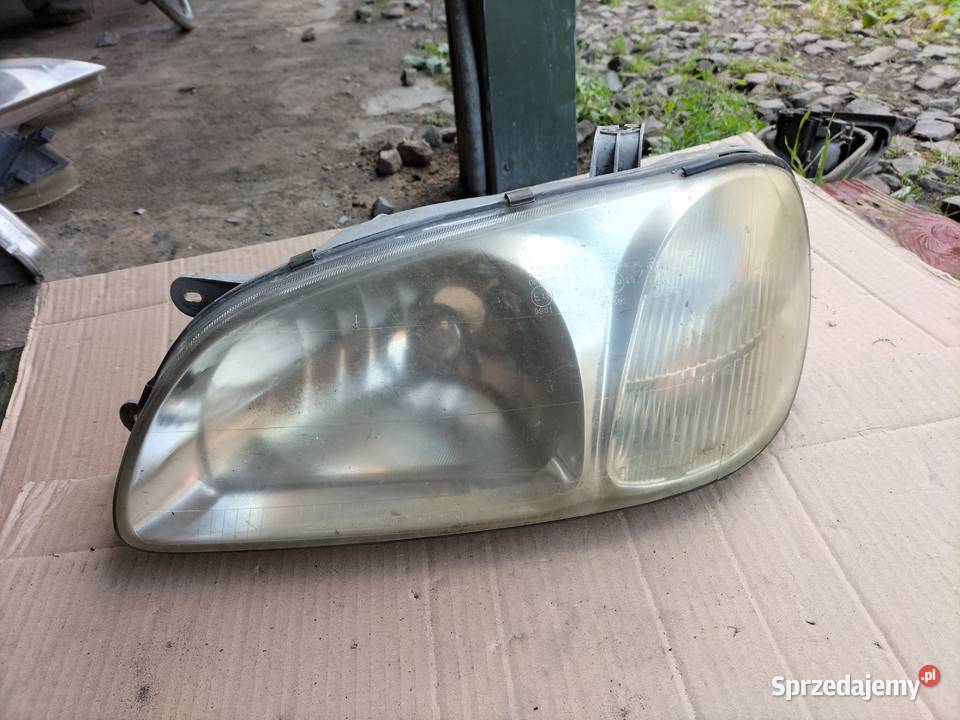 KIA CARNIVAL LAMPA PRZÓD LEWA Lewe Kamień-Kolonia