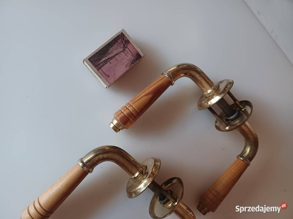Dwa komplety klamek Mosiądz drewno Poznań