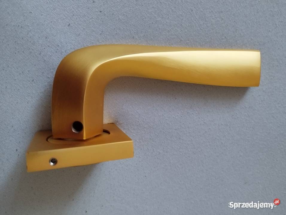 Klamka Adel na rozecie złoty mat Domino Szyld Olsztynek