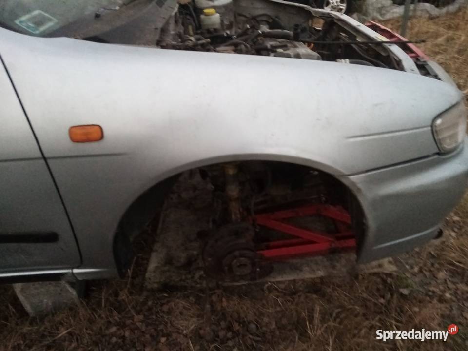 Blotnik przód prawy Nissan Almera N15 1 srebrny łódzkie Piotrów