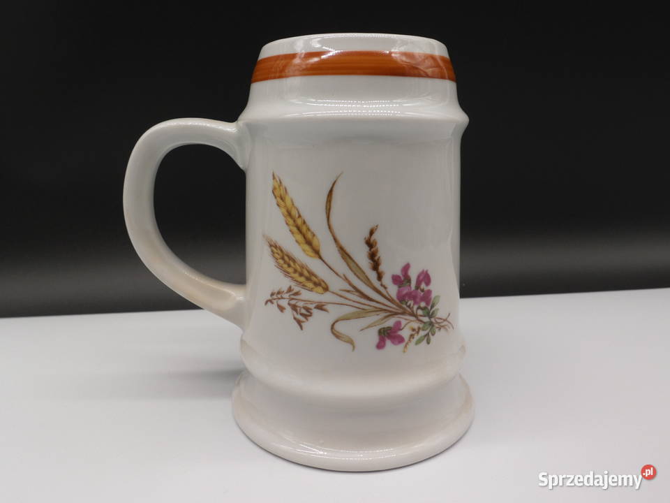 Ceramiczny kufel ozdobiony motywem kwiatów i Antyki Raszków