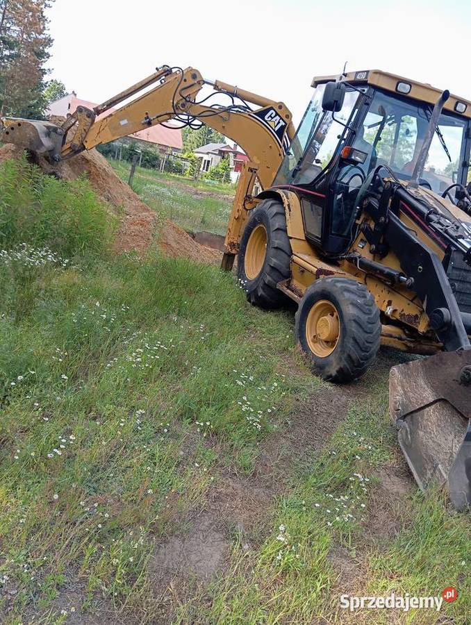 Usługi koparkoładowarką Cat 428D Pustków