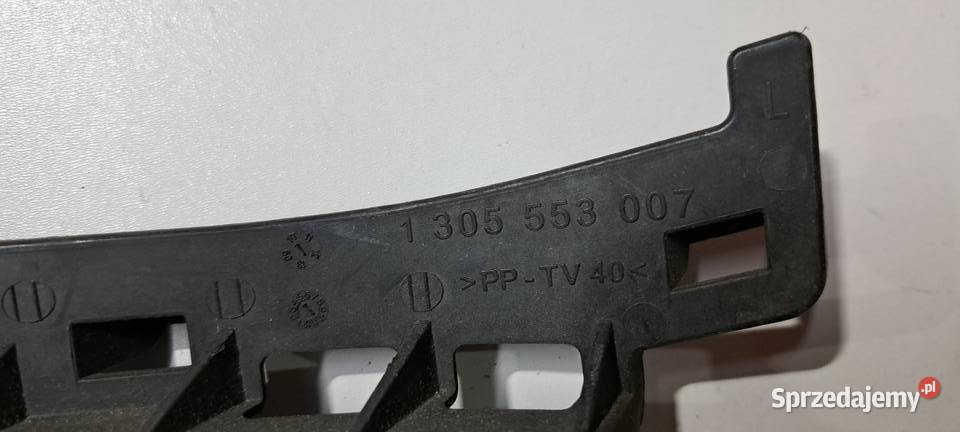 Ślizg mocowania reflektora lewy 1305553007 VW osobowe pomorskie Luzino
