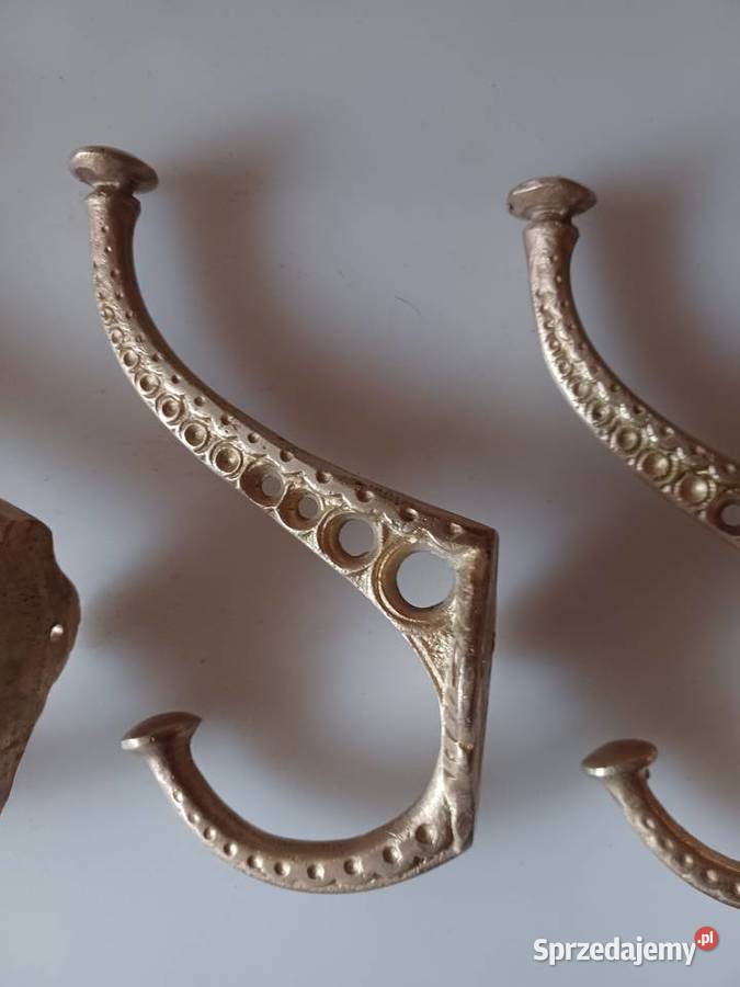Komplet czterech masywnych wieszaków mosiężnych Poznań sprzedam