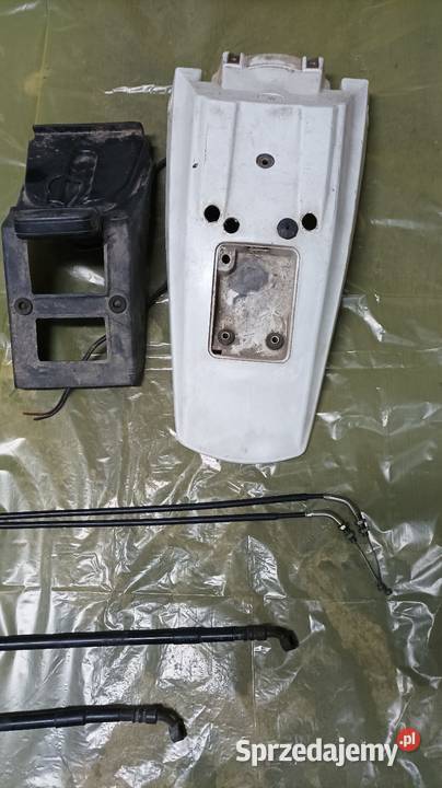 Błotnik lampa cewka WN linka rolgaz pompa zacisk