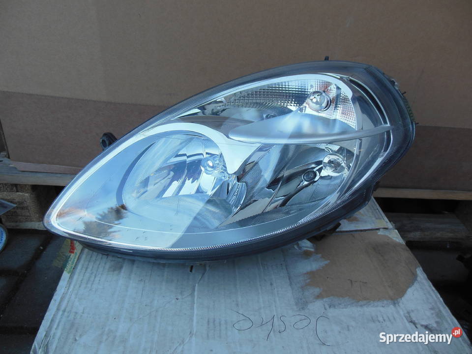 27053300 reflektor lancia mussa 2010 lewy przód Kozy