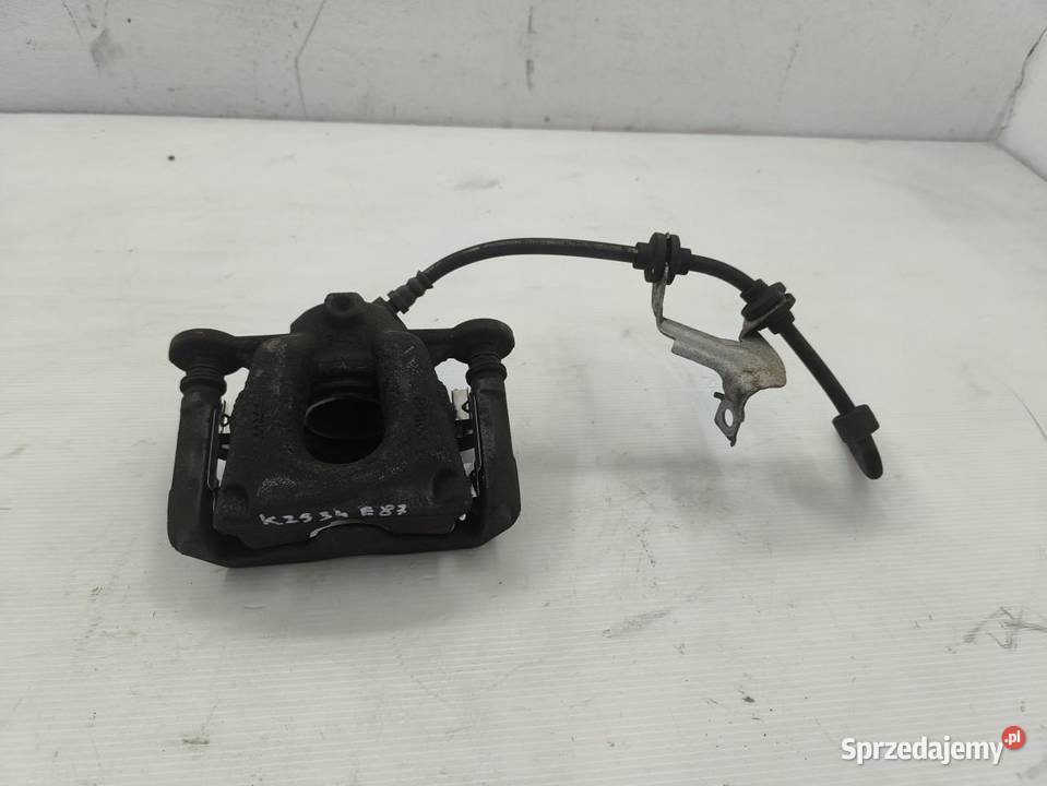 ZACISK LEWY TYŁ BMW 1 E87 E81 LIFT 16 osobowe