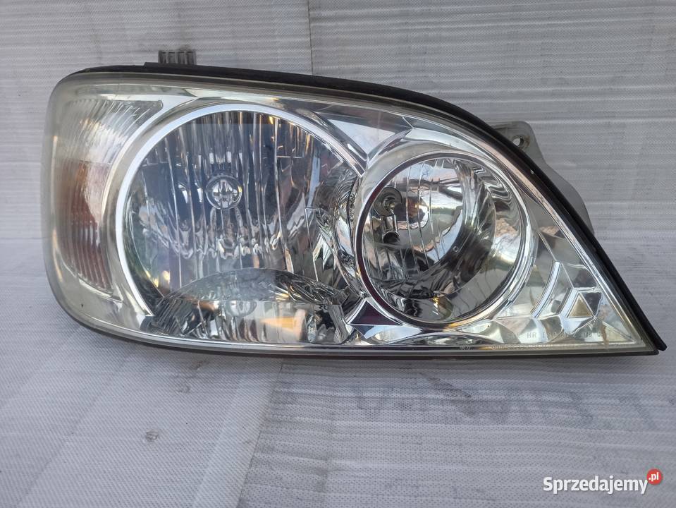 Kia Carnival 1 I lampa przednia prawa reflektor Sieradz