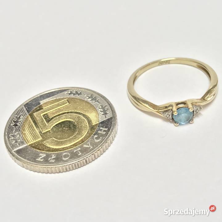 Złoty pierścionek 9K 375 z błękitnym topazem i Warszawa