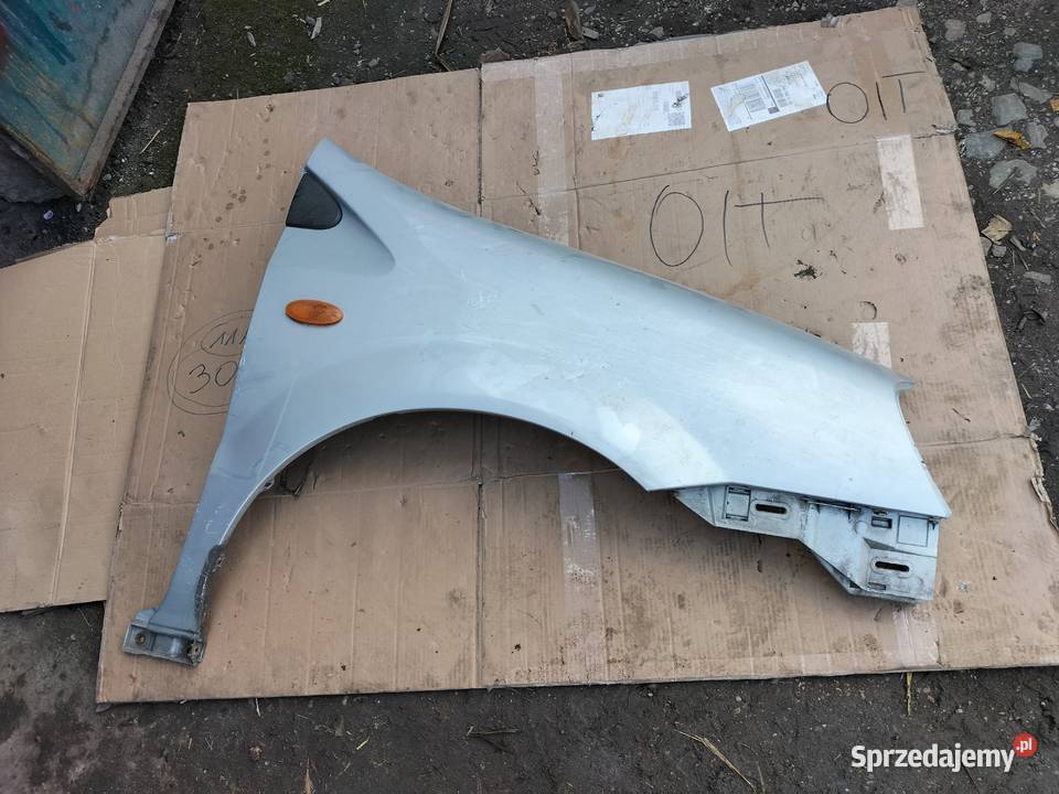 NISSAN ALMERA TINO BŁOTNIK PRAWY PRZÓD Kamień-Kolonia