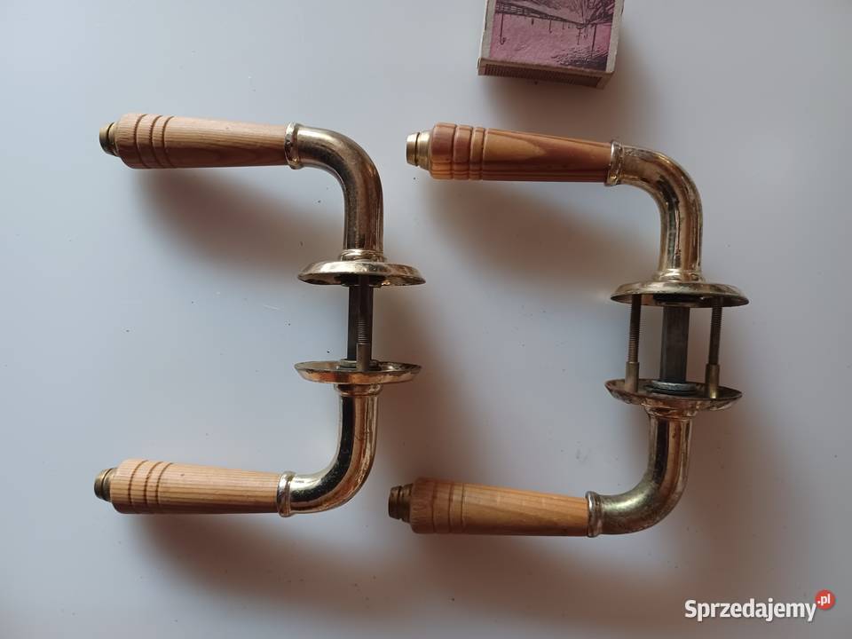 Dwa komplety klamek Mosiądz drewno Poznań
