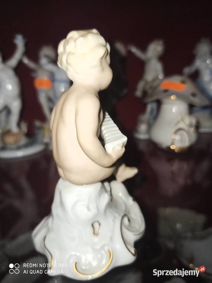 Figurka Puto z harmoszką Sygnatura Schaubach