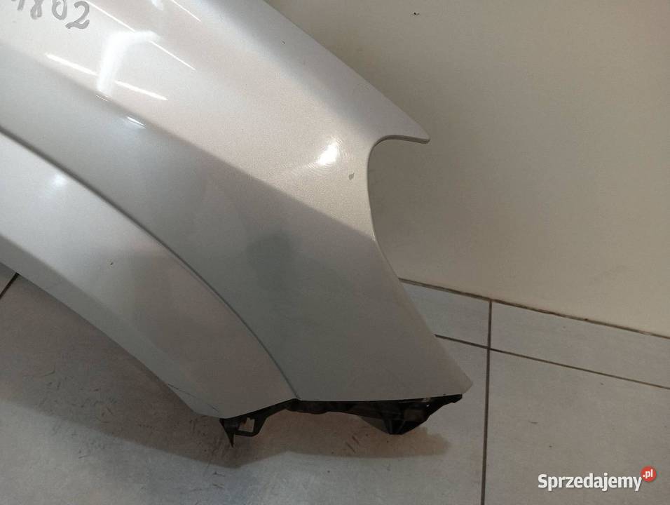 BŁOTNIK PRAWY PRZÓD SREBRNY Opel Astra III