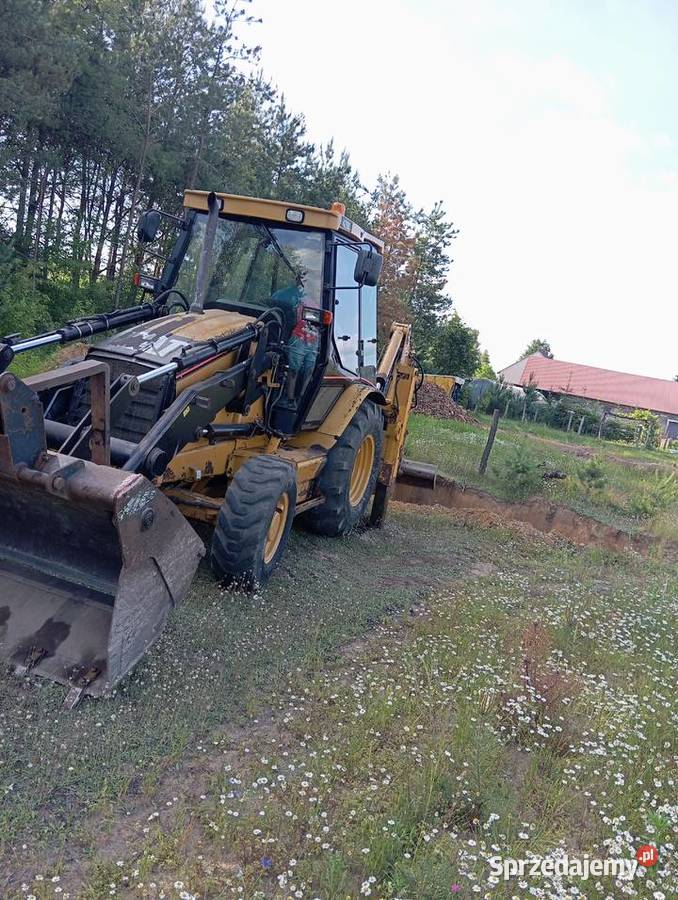 Usługi koparkoładowarką Cat 428D Pustków usługi budowlane