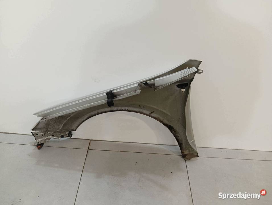 BŁOTNIK PRAWY PRZÓD SREBRNY Opel Astra III