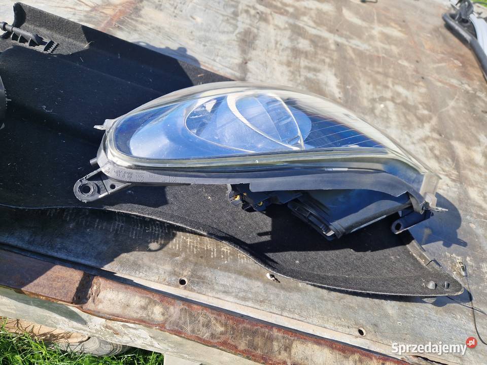 Opel Corsa D reflektor ORG EU Mielec