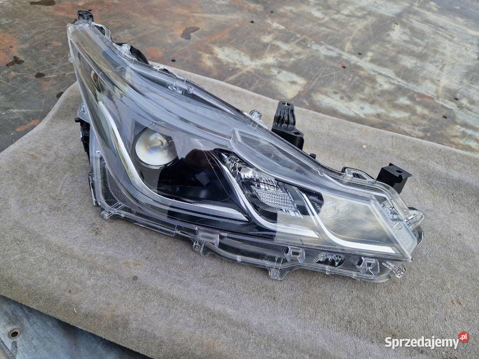 Toyota Corolla E21 sedan reflektor ORG EU Mielec