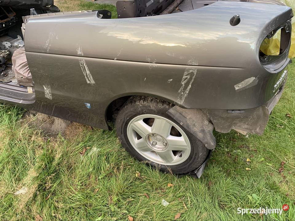 RENAULT MEGANE I CABRIO BŁOTNIK LEWY TYŁ osobowe Błotniki