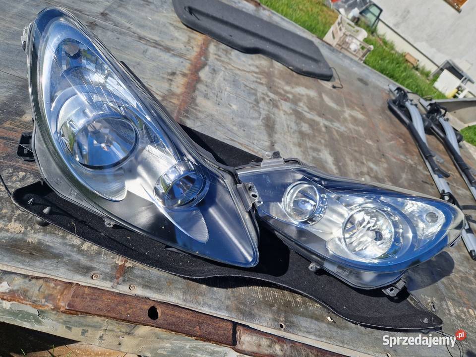 Opel Corsa D reflektor ORG EU osobowe podkarpackie Mielec