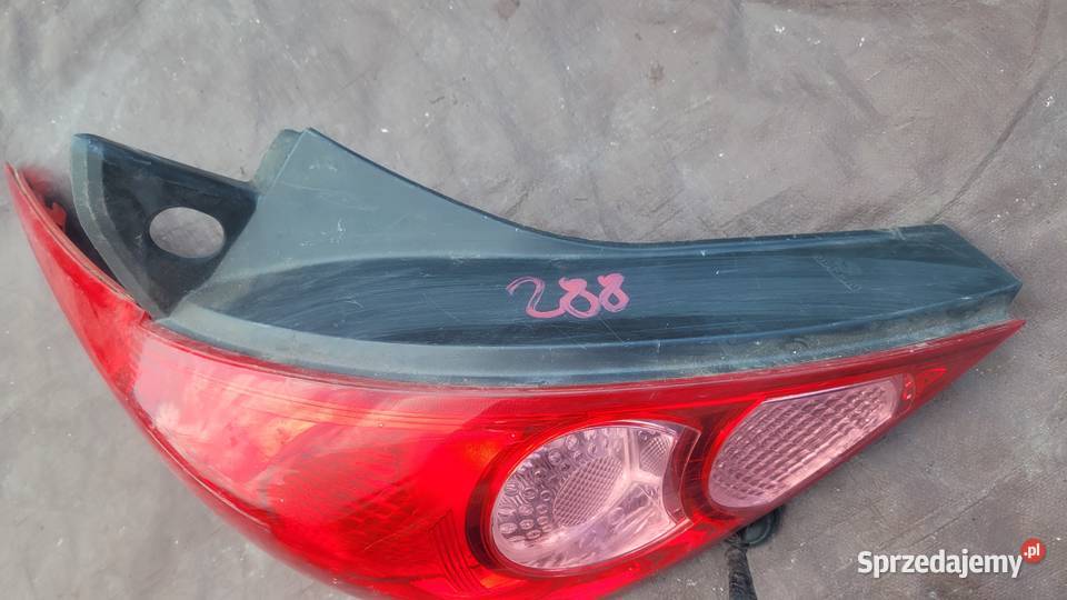 NISSAN TIIDA 5D LAMPA TYŁ LEWA 26555EM01A HELLA Ruda Śląska