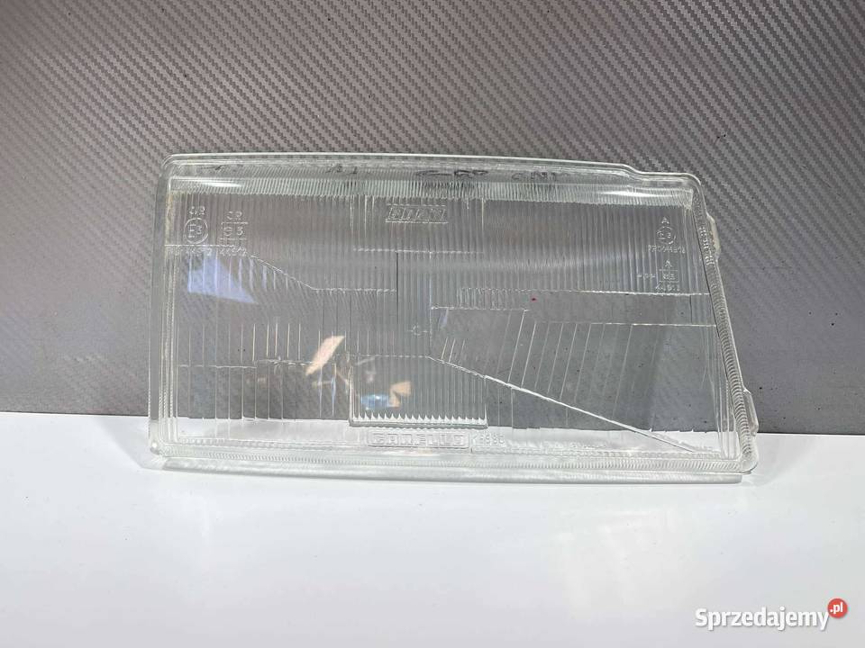 FIAT UNO PRAWY KLOSZ ORYGINAŁ CARELLO 1989 osobowe Lampy przednie Ostroróg