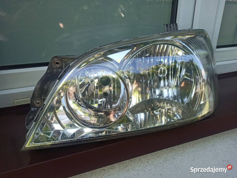 Kia Carnival 1 I lampa przednia lewa reflektor Lampy przednie Sieradz