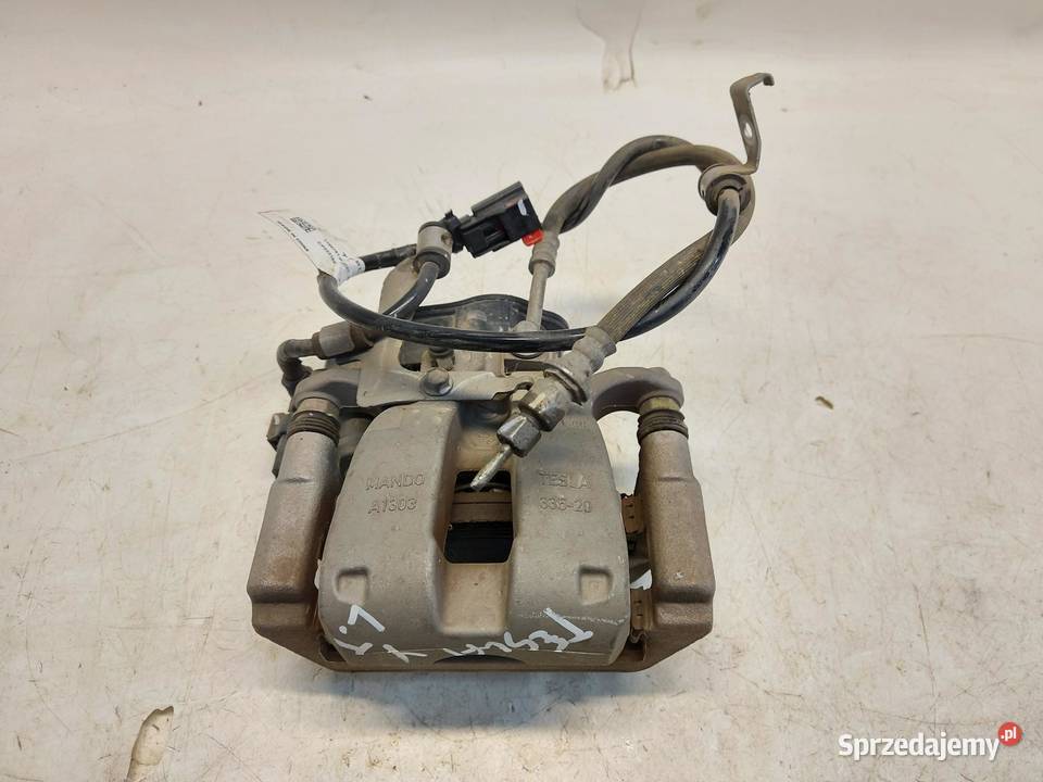 TESLA MODEL Y 2022r ZACISK HAMULCOWY LEWY TYŁ