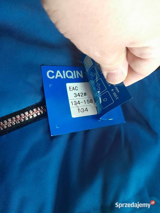 Niebieska kurtka przejściowa marki Caigin z