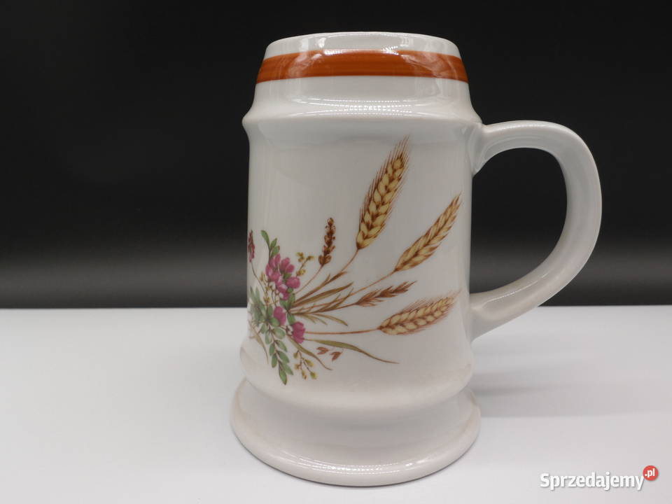 Ceramiczny kufel ozdobiony motywem kwiatów i Raszków