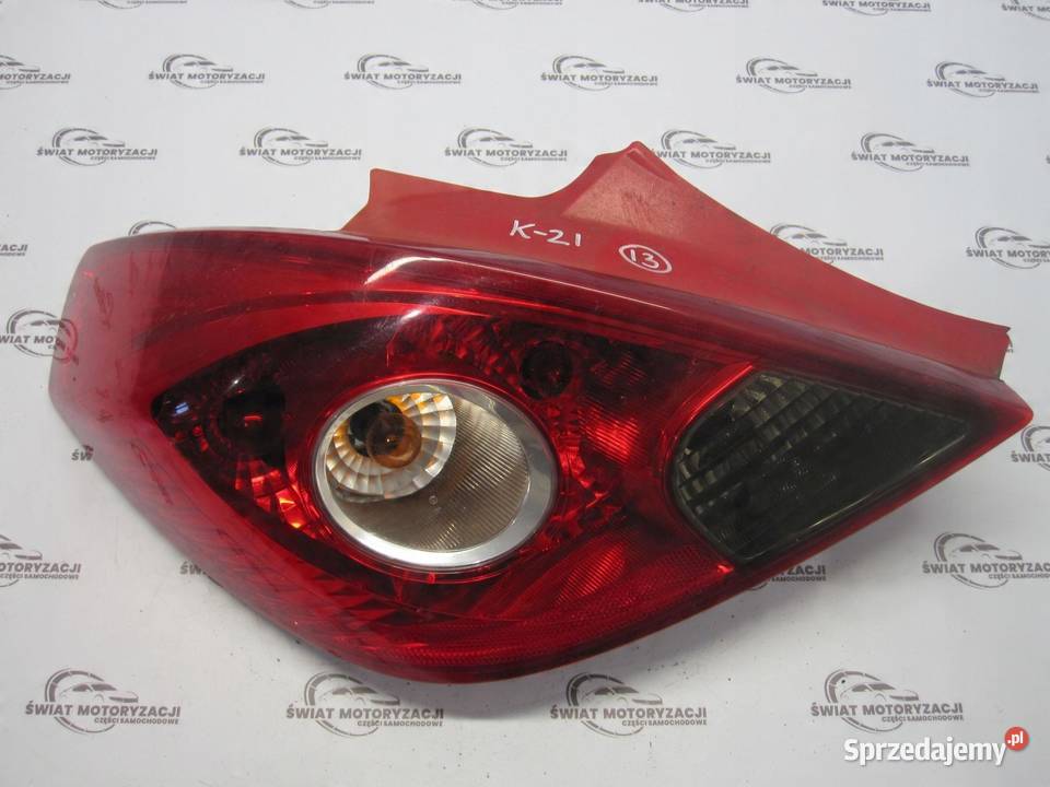 OPEL CORSA D lampa lewa tył 13211840 89038962A