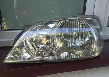 Kia Carnival 1 I lampa przednia lewa reflektor przód kierowcy