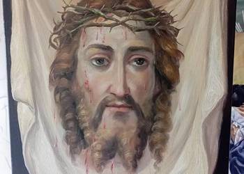Obraz z odbiciem twarzy Jesusa na plotnie