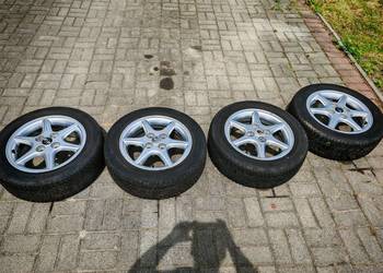 Felgi aluminiowe Nissan Almera N16 z oponami Hankook Kinergy 4S2 - 4 sztuki
