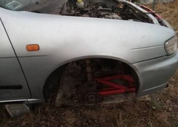 Blotnik przód prawy Nissan Almera N15 KG1 srebrny