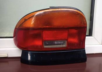 Mazda 121 lampa tył tylna lewa listwa maskująca wkład
