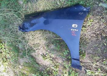 Corolla E12 Blotnik lewy przod oryginal