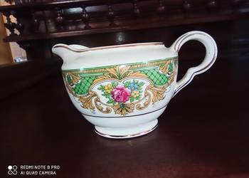 Mlecznik z kwiatami i zieloną dekoracją.  Vitreous. Jonh Mad