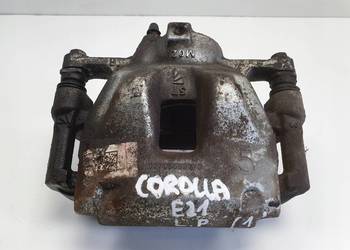 Toyota Corolla XII E21 PRZEDNI ZACISK HAMULCOWY prawy przód PASAŻERA P.P