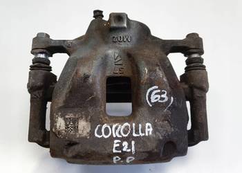 Toyota Corolla XII E21 PRZEDNI ZACISK HAMULCOWY prawy przód PASAŻERA P.P