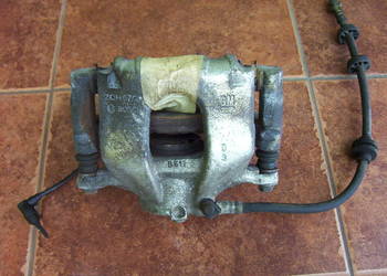 Opel Corsa D zacisk hamulca / hamulcowy - jarzmo - tarcza OE