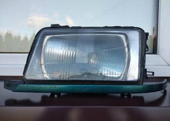 Audi 80 B4 lampa przednia lewa reflektor przód kierowcy Hella listwa